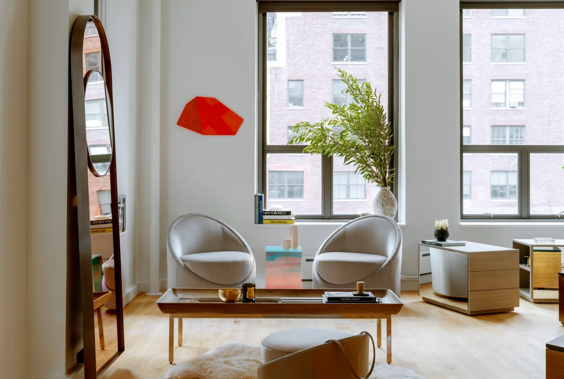 a living room with a large round rug and chairs